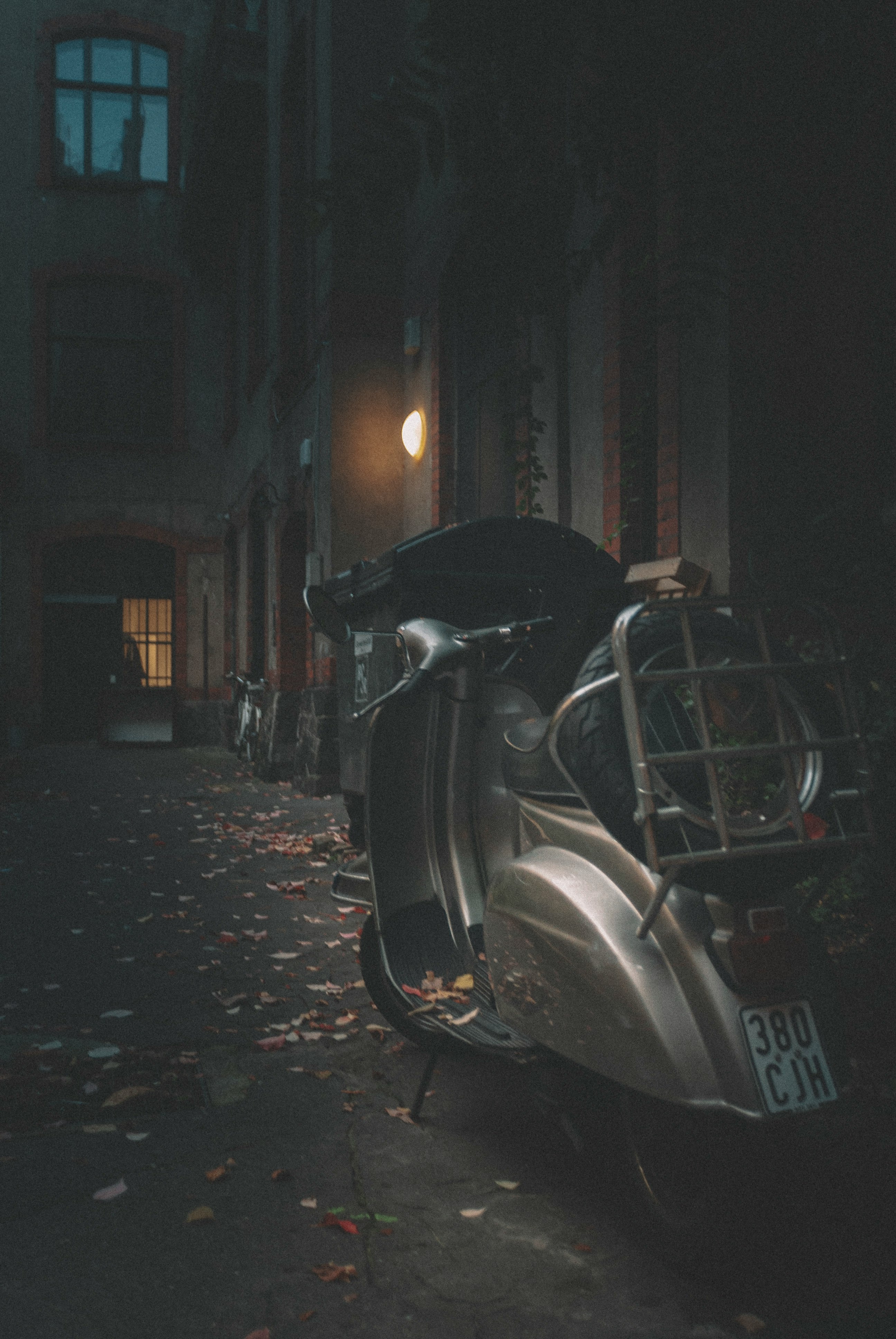 black motorcycle parked on sidewalk during night time